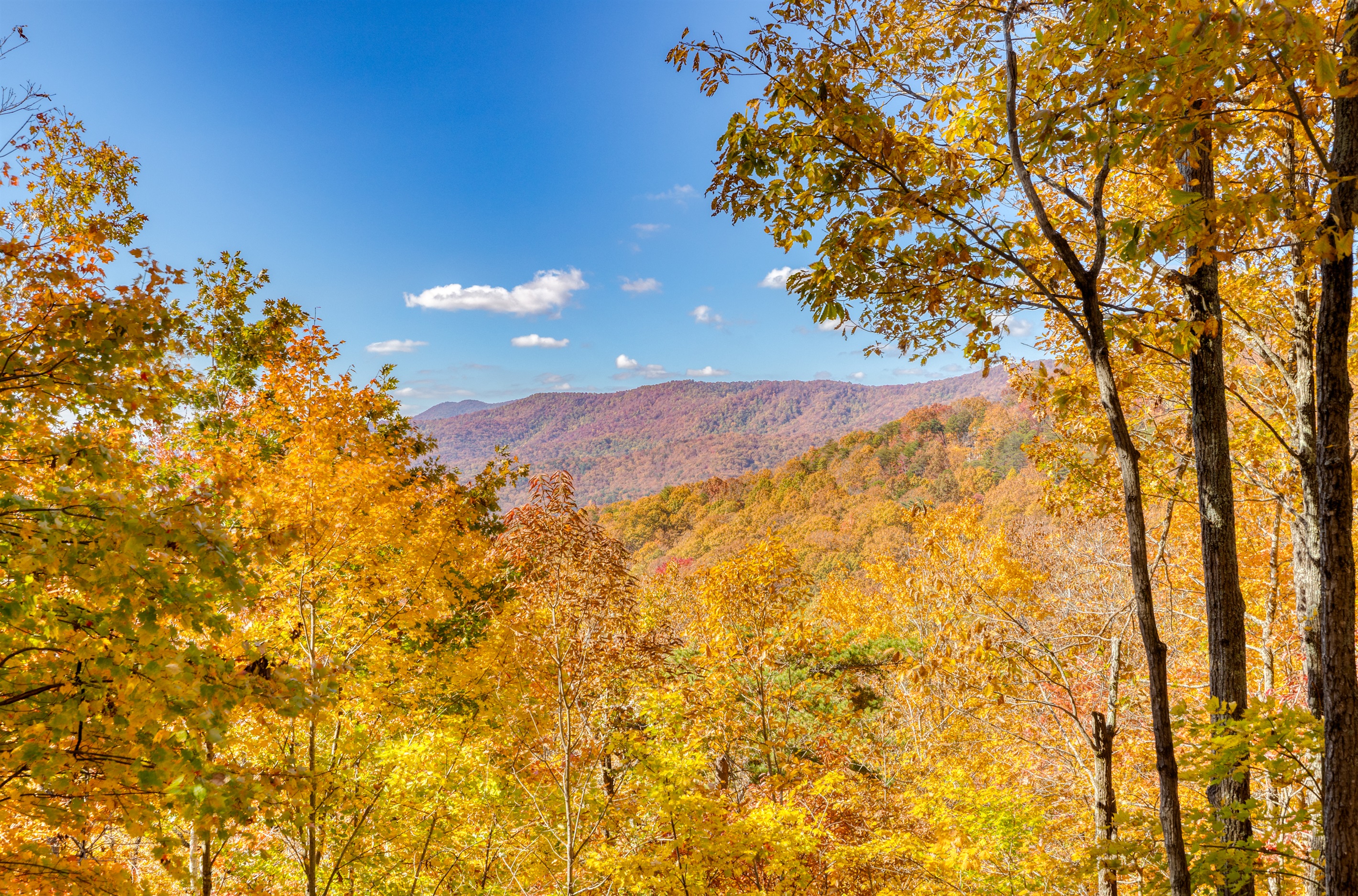 This is the view of the valley, mountains and sunset from our top level front porch, right by the front door.  This level of deck also has the gas grill, outdoor dining table, rocking chairs and swing.