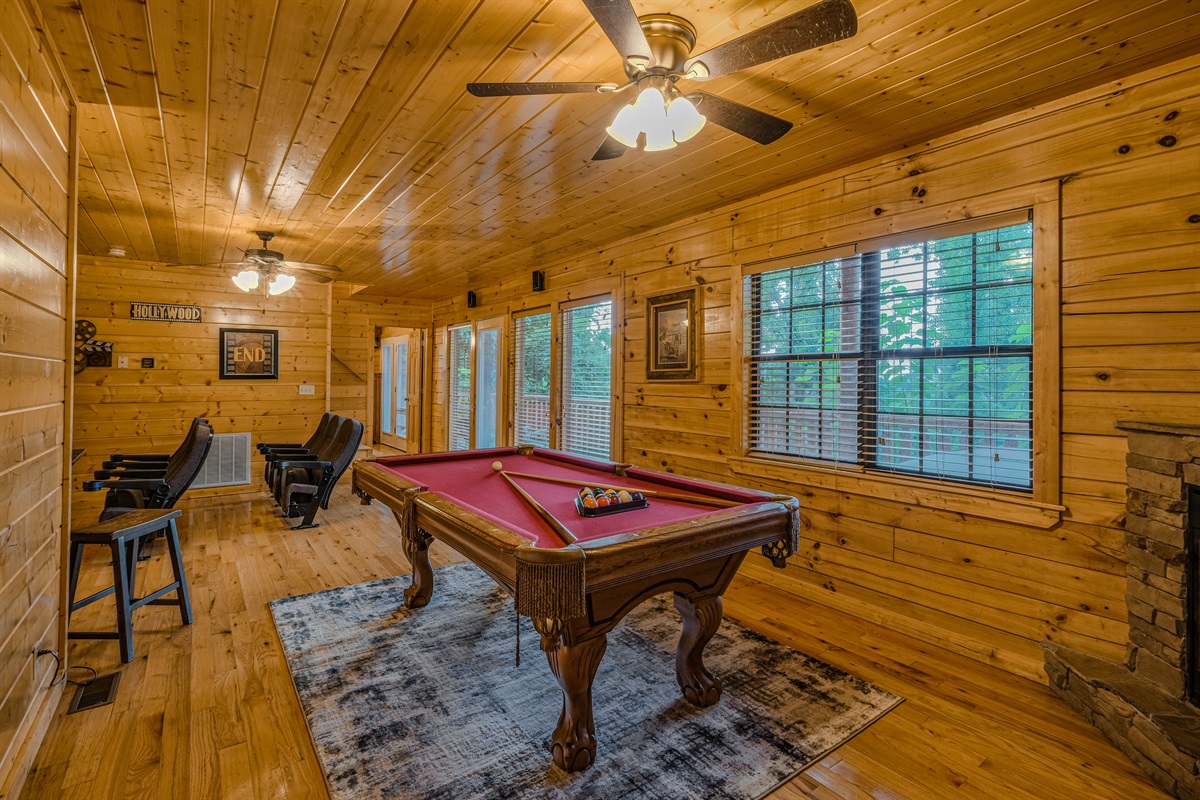 Game room with pool table and theater area in the background