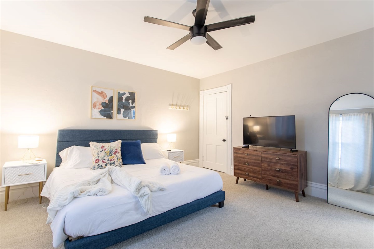 Discover the King Bedroom, a spacious room on the second floor with king bed flanked by nightstands with lamps.