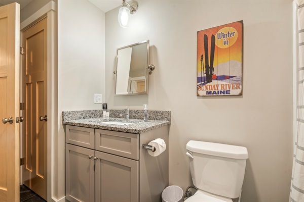 Basement bathroom featuring a full shower and tub combination with toilet.