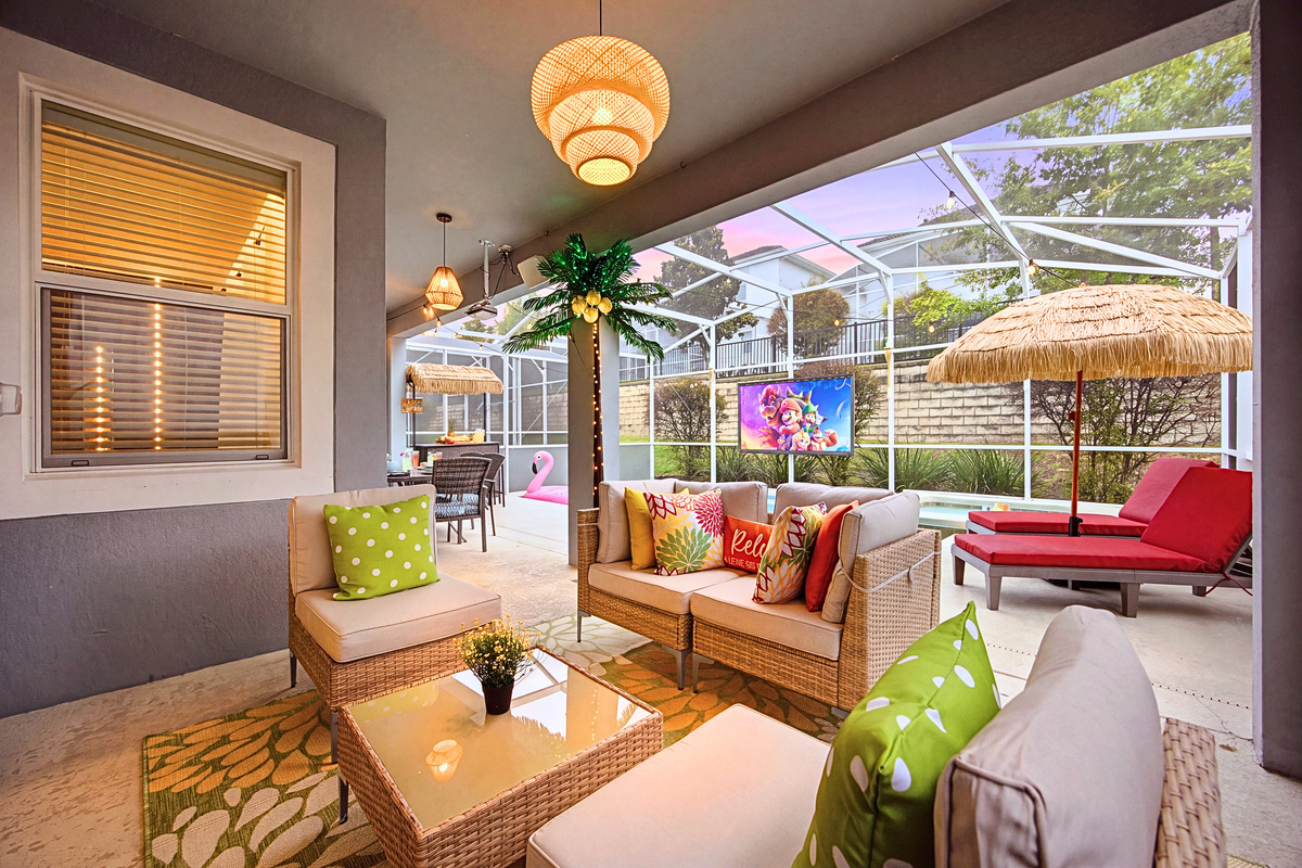 Your own tropical paradise! Unwind on cozy outdoor sofas beneath twinkling lights, with a poolside movie, tiki bar, and plenty of space to relax.