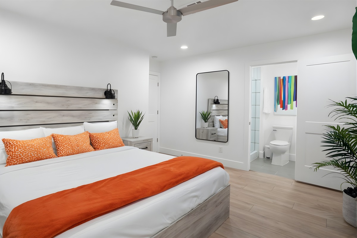 The primary bedroom features a king-size bed and an ensuite bathroom.