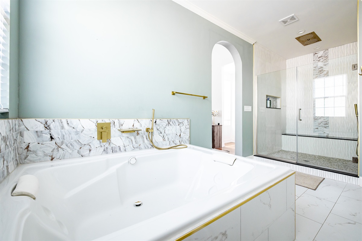 Luxury en-suite bathroom with 2-person air massaging bath, tiled rain shower, and double vanity