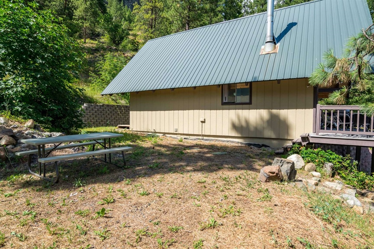 Picnic table outside for dining under the pines.