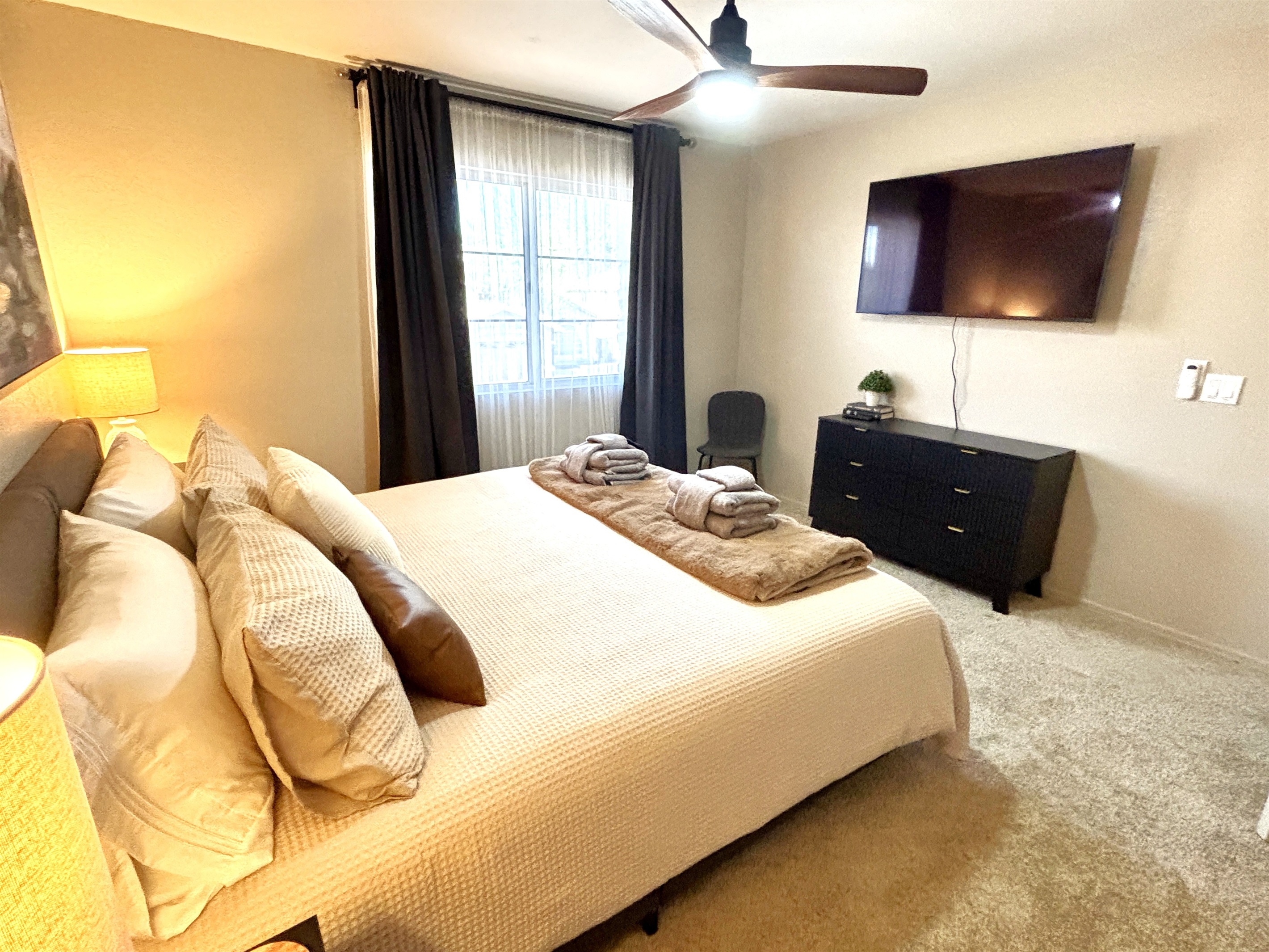 King bedroom upstairs with 55" Smart TV, Blackout curtains and ceiling fan