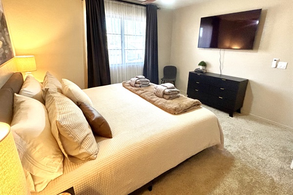 King bedroom upstairs with 55" Smart TV, Blackout curtains and ceiling fan