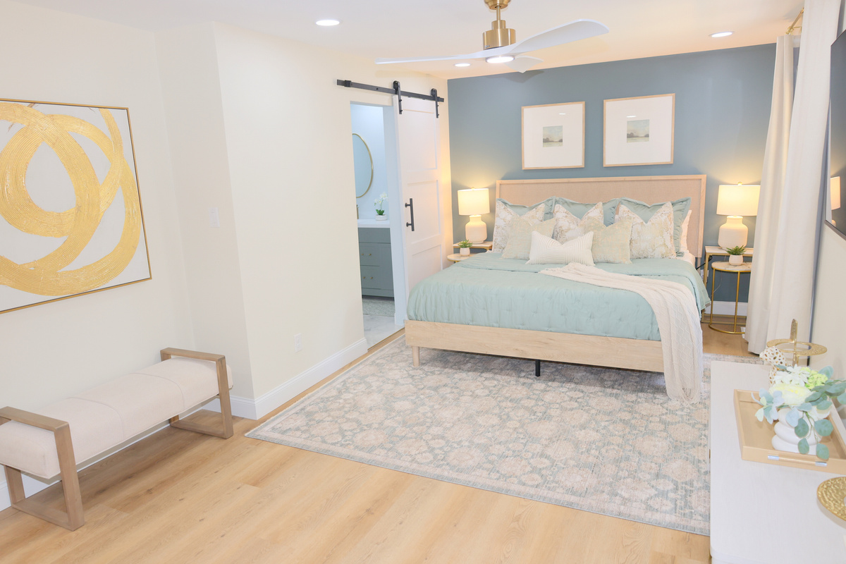 Spacious bedroom with calming décor, comfortable bedding, TV, and plenty of room to unwind