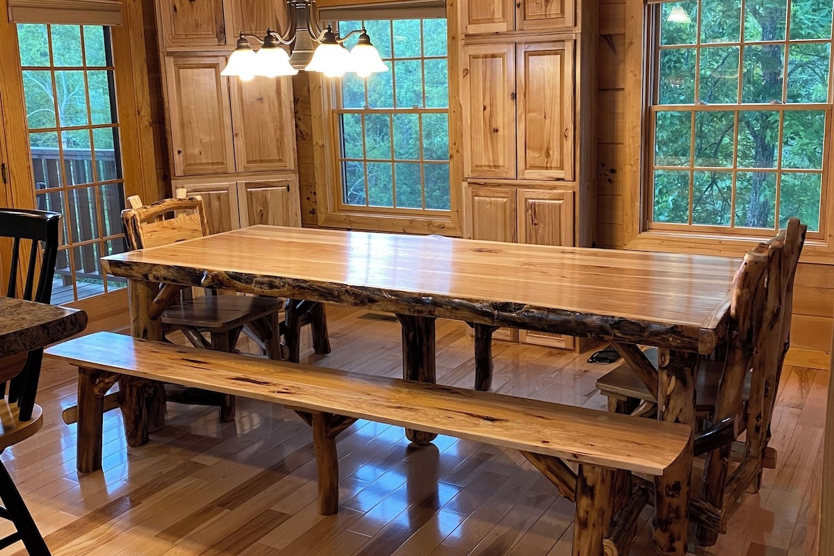 The Dining area has a huge 9 foot table with lots of room for large groups to eat at the table, the counter with highback chairs, a pull-up coffee table in the living room, and a large table on the front porch. There are also more tables on the patios.