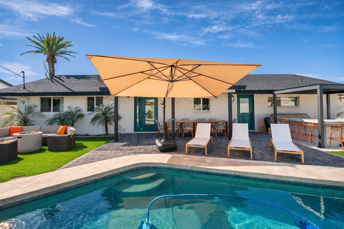 Enjoy a resort-style private pool surrounded by loungers and umbrella shade — ideal for relaxing, sunbathing, and group gatherings.