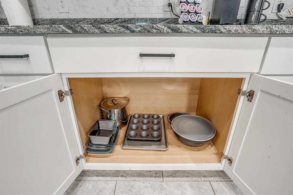 Cabinet drawer with cookware, trays, and bakeware included.