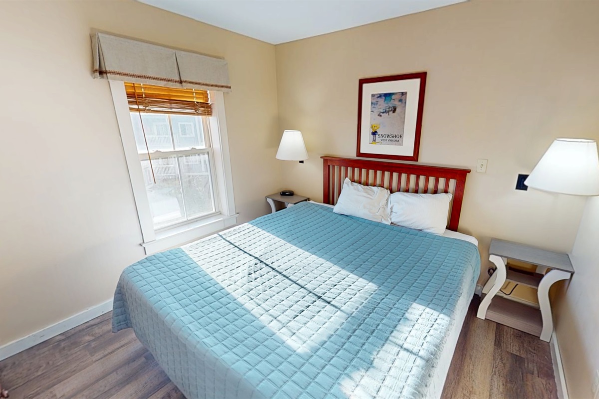 Rest easy: serene primary with a plush king bed and soft linens.