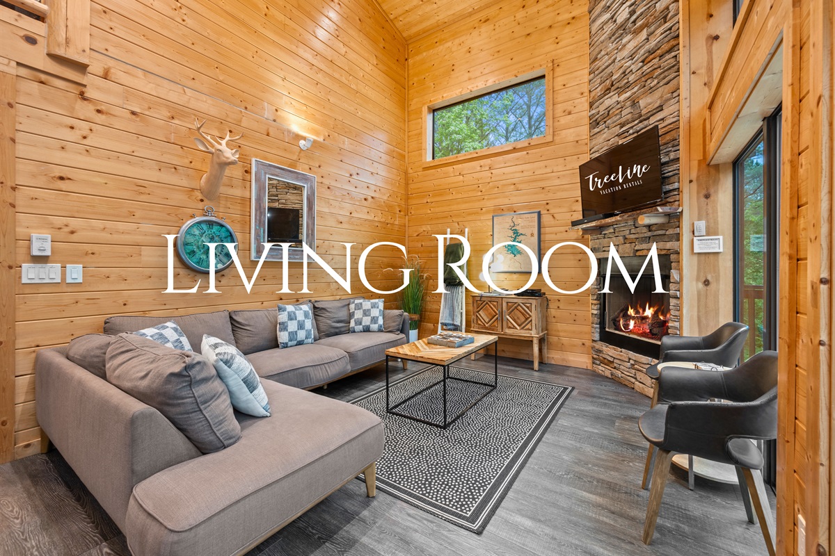 Walking into the living room, you’re greeted by comfortable seating and warm wood finishes that instantly make the space feel welcoming.