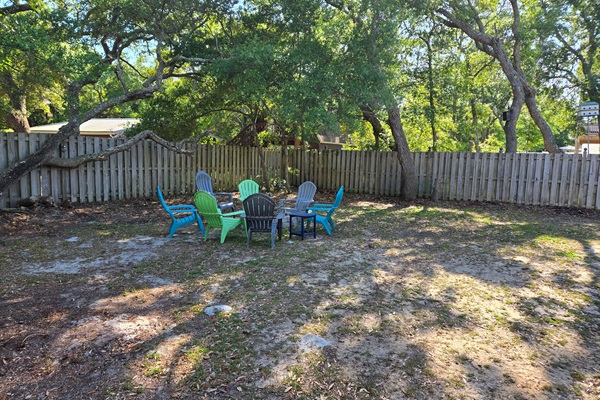 Large fenced in backyard with beautiful live oak trees