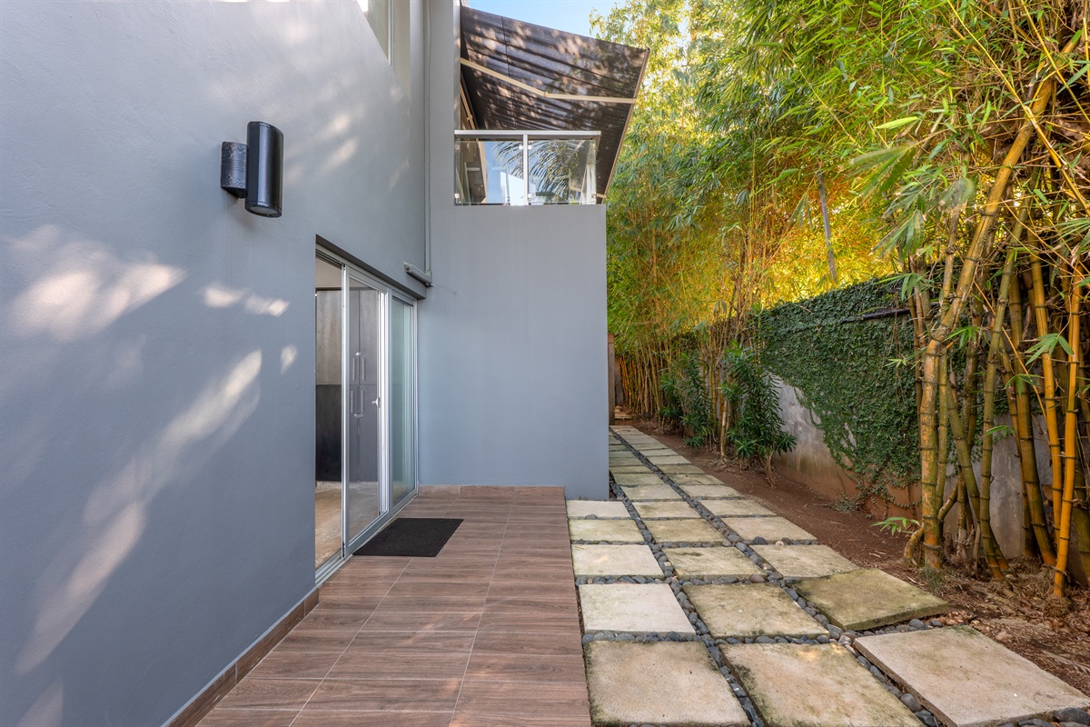 Quiet side patio perfect for fresh air and privacy.