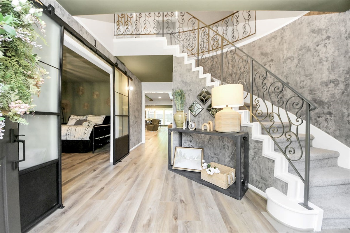 Gorgeous entrance with new flooring, fresh paint and curved staircase entrance.