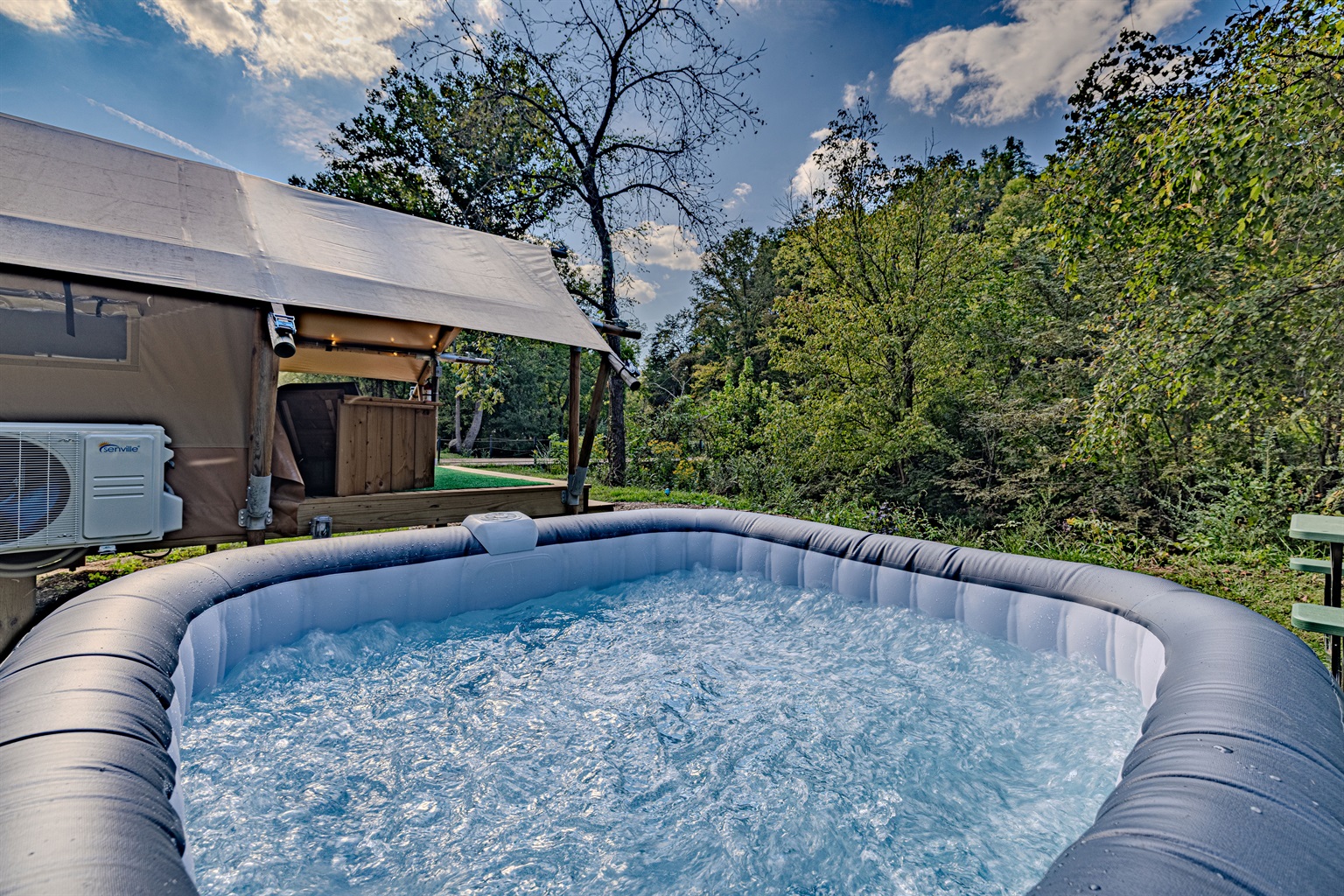Enjoy the best of both worlds with a backyard built for relaxation. The hot tub and surrounding seating create a tranquil and private retreat.