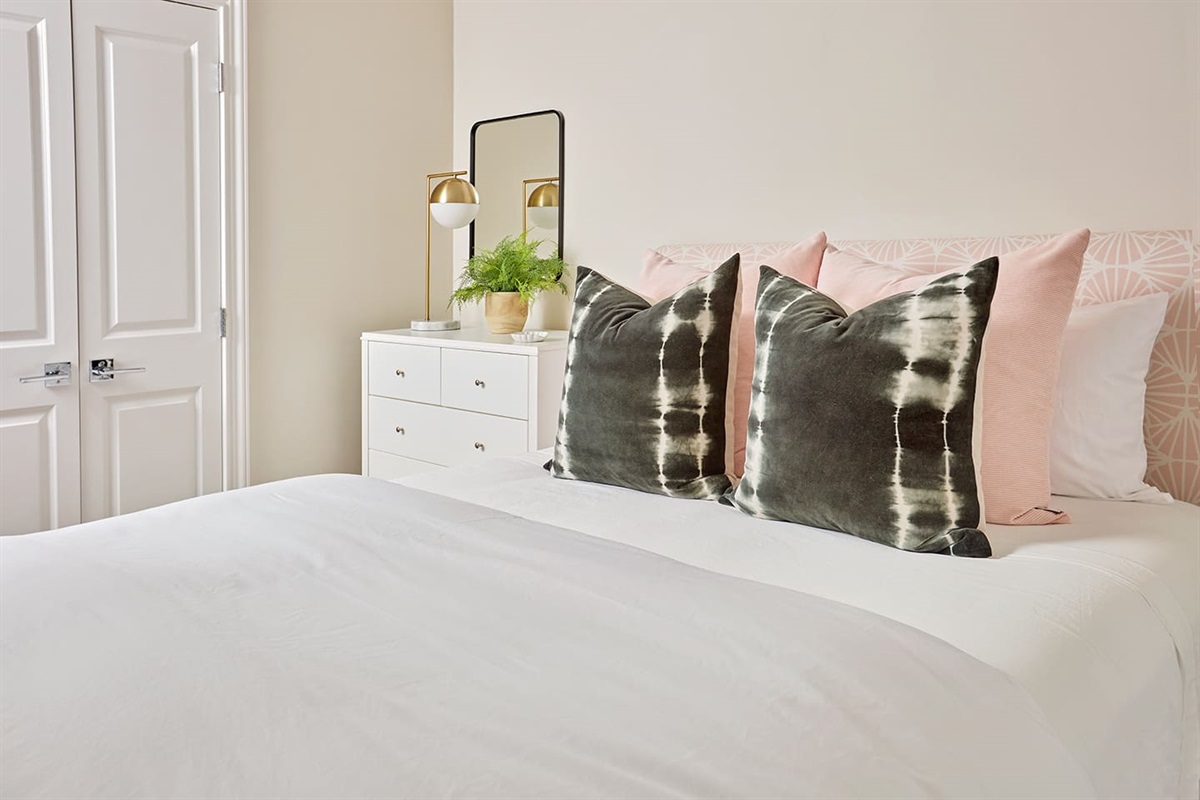Enjoy a restful nights sleep in a lovely Queen bedroom featuring an award winning premium Winkbed mattress, cozy down comforter and pillows, 800-thread-count linens, a nice size closet and dresser, and a smart TV overlooking the private patio.