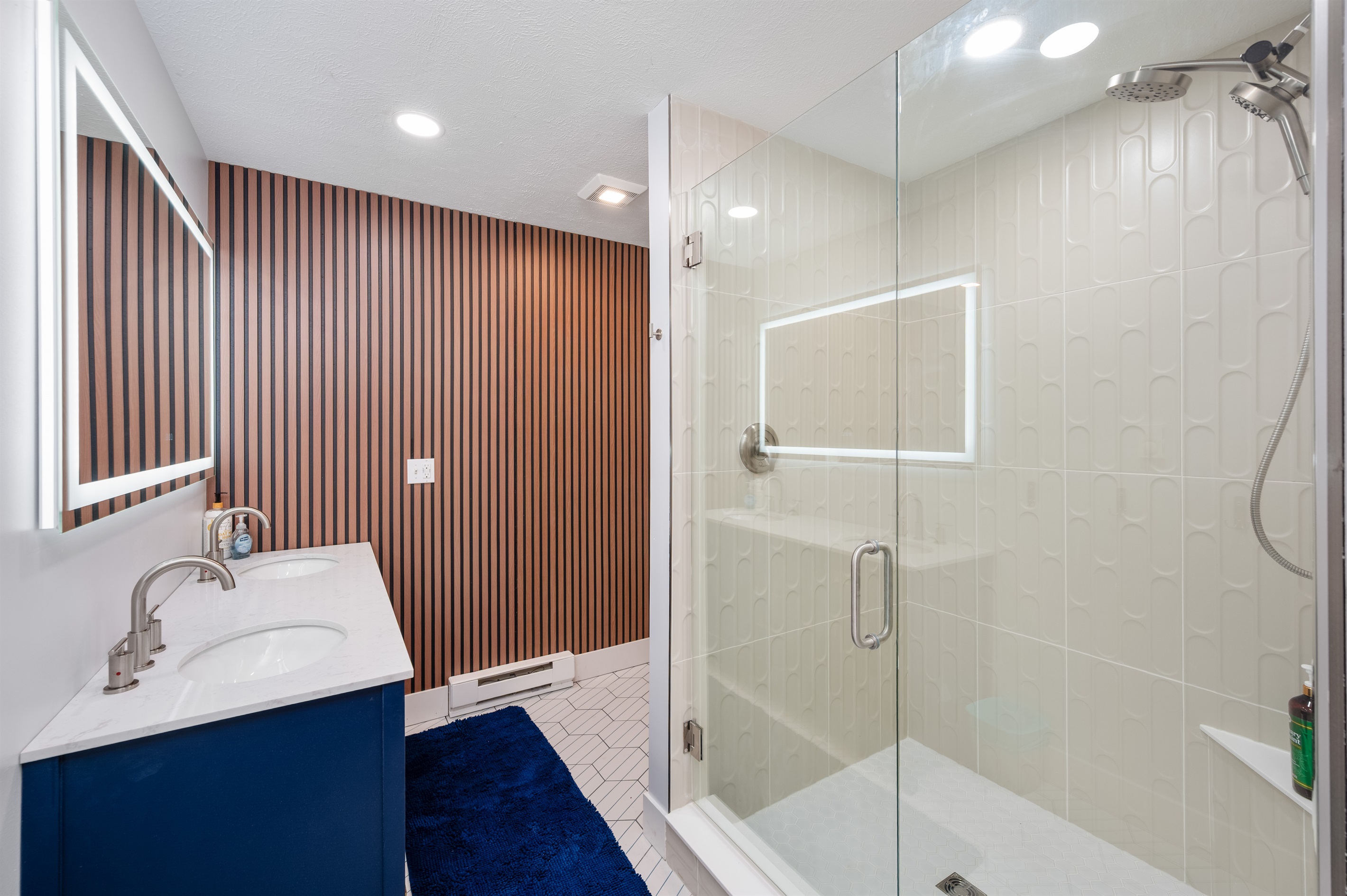 Upstairs spacious bathroom with modern finishes and glass shower