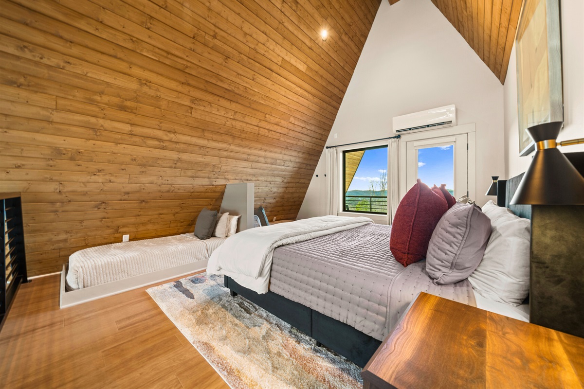 The sloped ceilings and soft lighting make this bedroom feel like a tucked-away hideout, perfect for quiet nights and slow mornings.