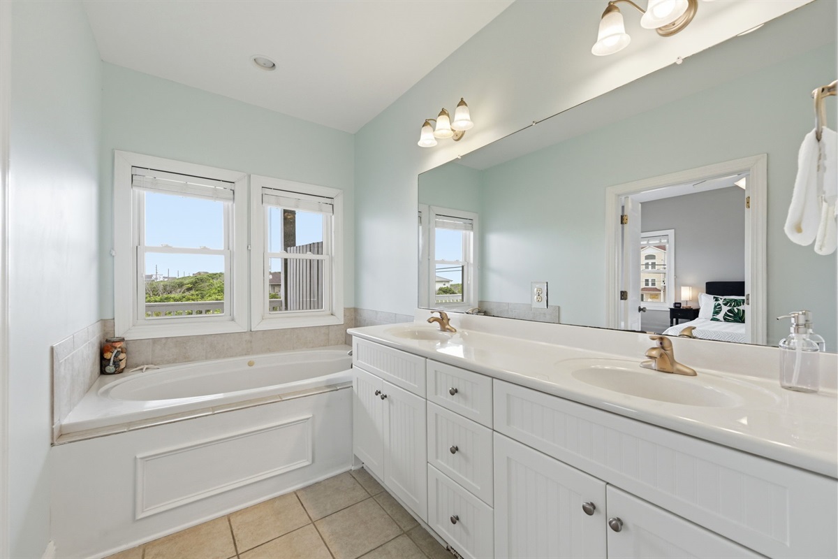Spacious master bathroom with double vanity and natural light