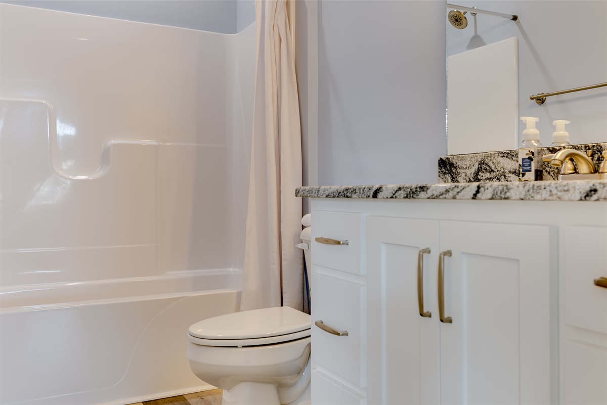 Crisp white finishes and warm lighting create a calm, hotel-style feel