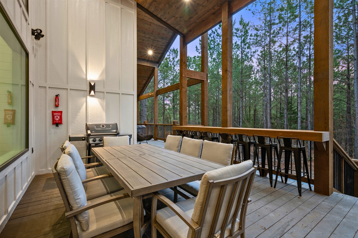 A large outdoor dining table makes it easy for everyone to gather together for meals, morning coffee, or late-night conversations.