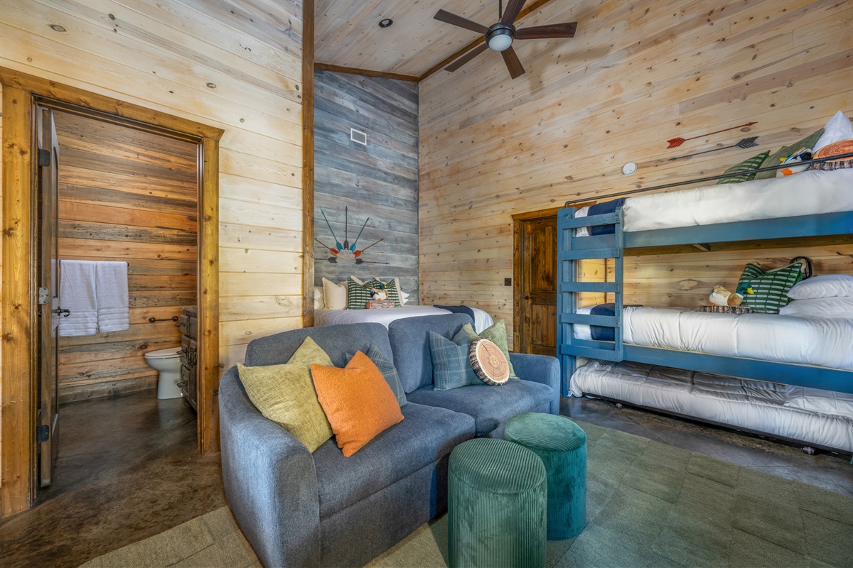 Bunk Room: Fun and vibrant space with bunks and a comfy lounge area for family adventures!