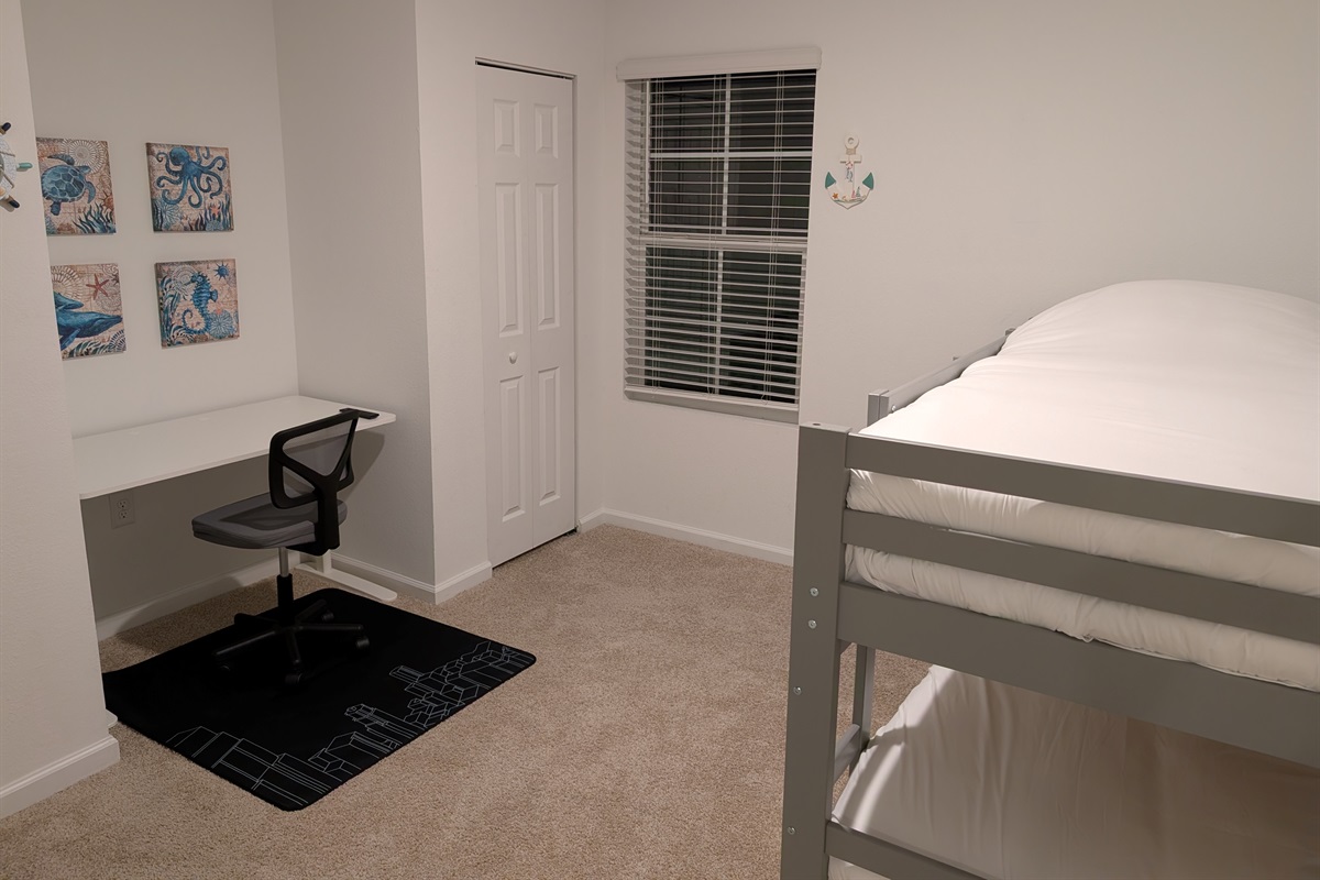 Kid room with 2 bunk beds, and a work desk for work at home
