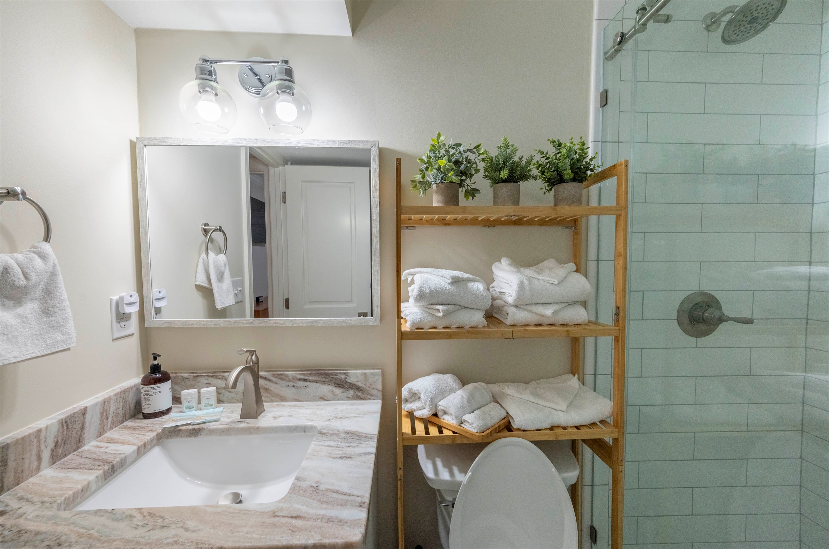 Enjoy this modern, fully equipped full bath on the first floor, complete with fresh towels and essentials!