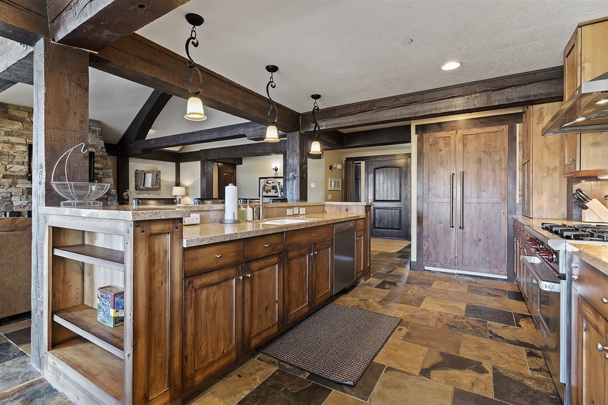 A fully equipped kitchen showcasing craftsmanship and functionality, with ample storage and upscale finishes that enhance every culinary experience.