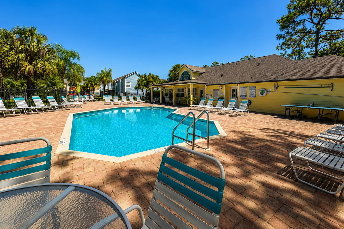 Resort-style community pool with plenty of lounge seating.