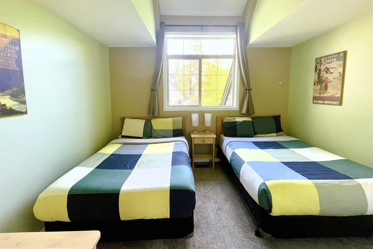 Guest bedroom with, two double beds. Vaulted ceilings and light blocking curtains. Adjacent bathroom in hallway. Located on 2nd floor.  