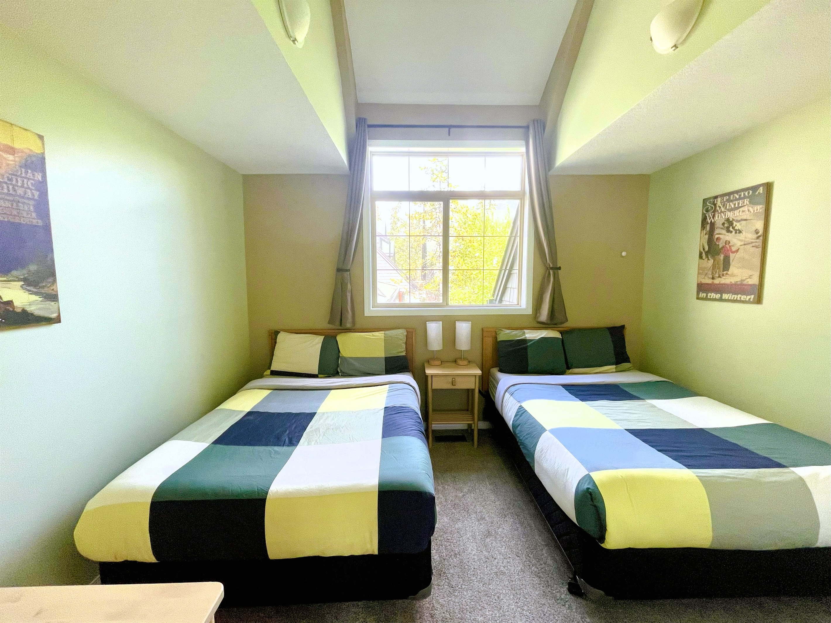 Guest bedroom with, two double beds. Vaulted ceilings and light blocking curtains. Adjacent bathroom in hallway. Located on 2nd floor.  