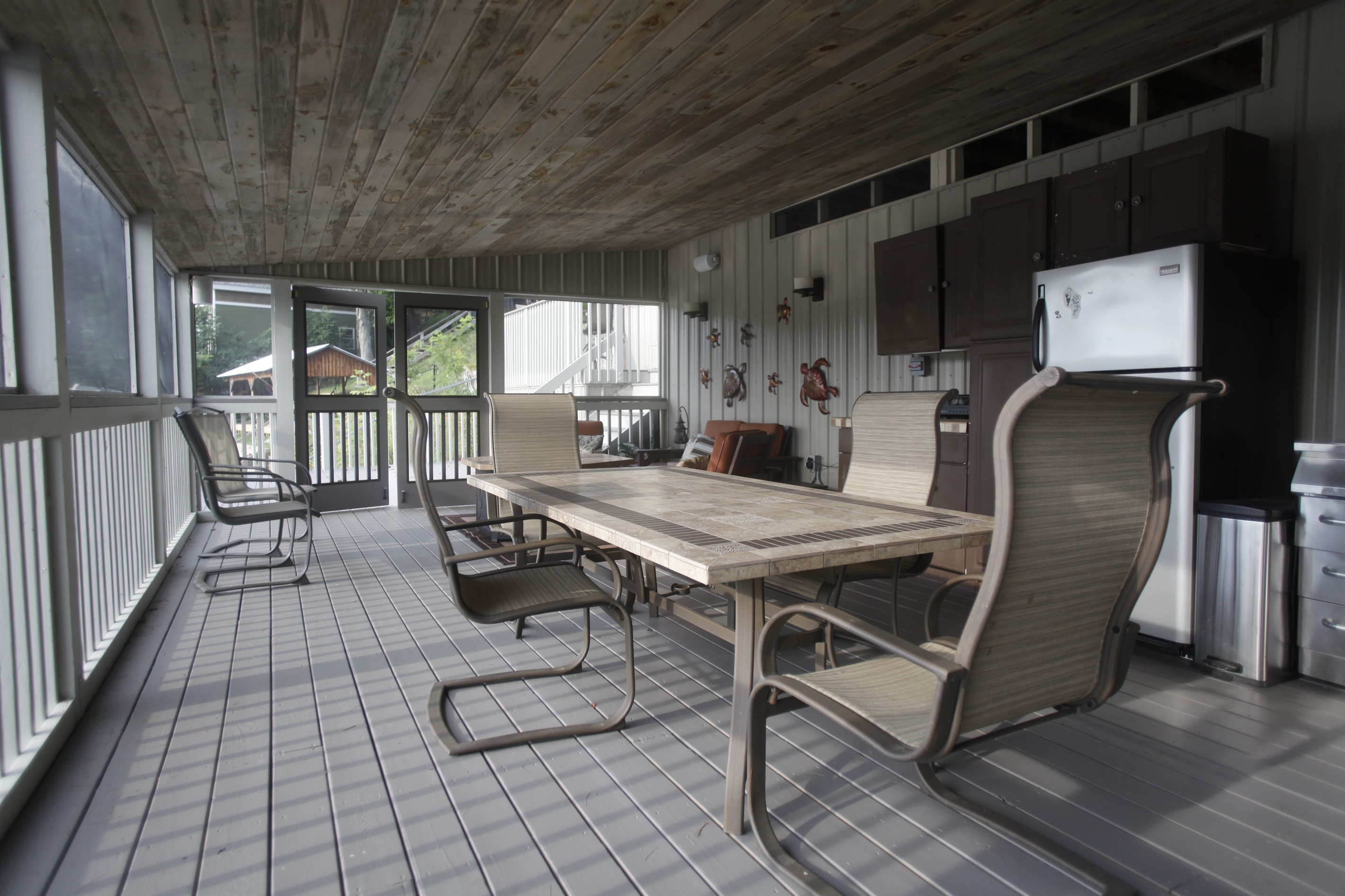 Lower deck cabana with fridge and dining