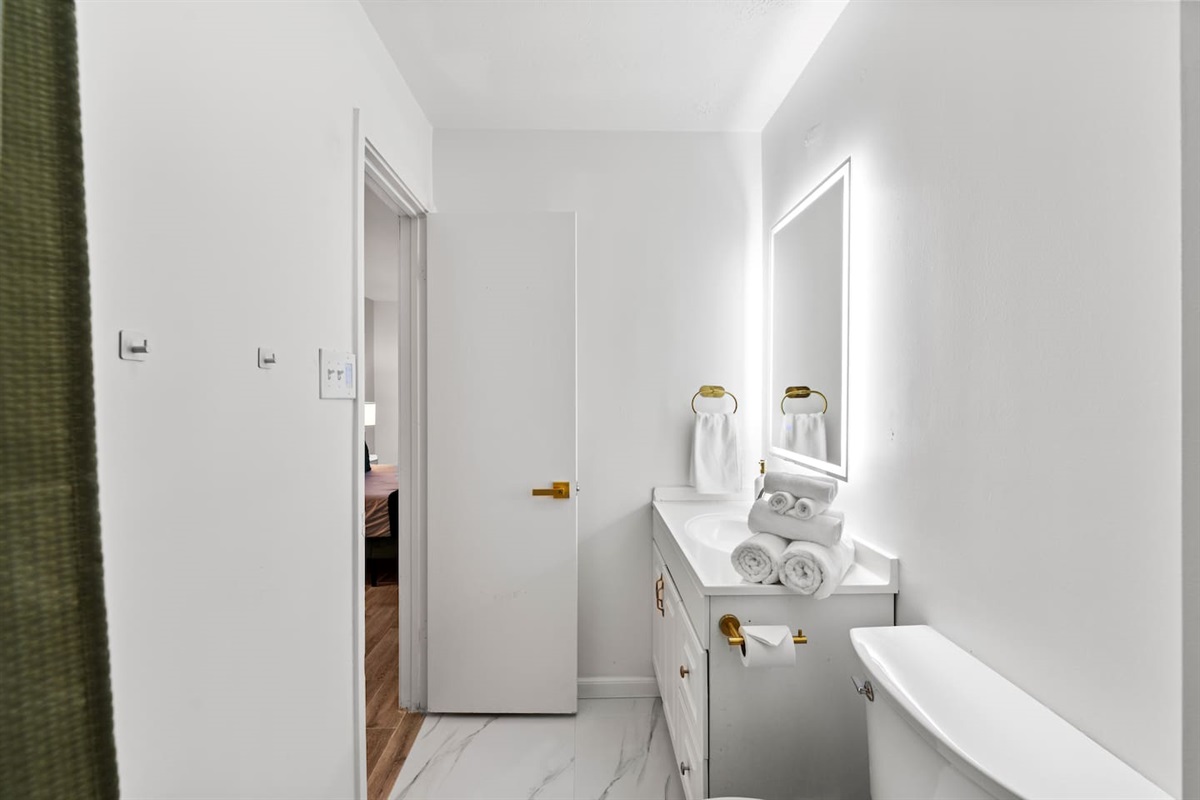 Bright, spacious bathroom with luxury finishes and large vanity.