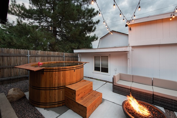 Cedarwood soaking hot tub in front of backyard ADU (in white).