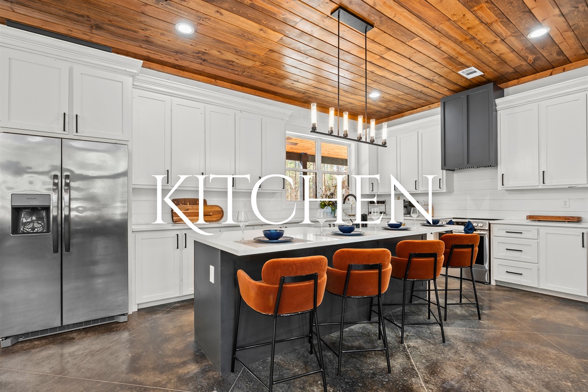 This beautifully designed kitchen offers top-of-the-line appliances, plenty of counter space, and an oversized island perfect for meal prep or casual dining.