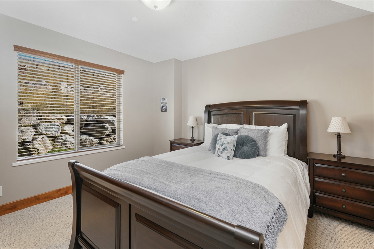 Another inviting bedroom with natural light and a calm, cozy atmosphere.