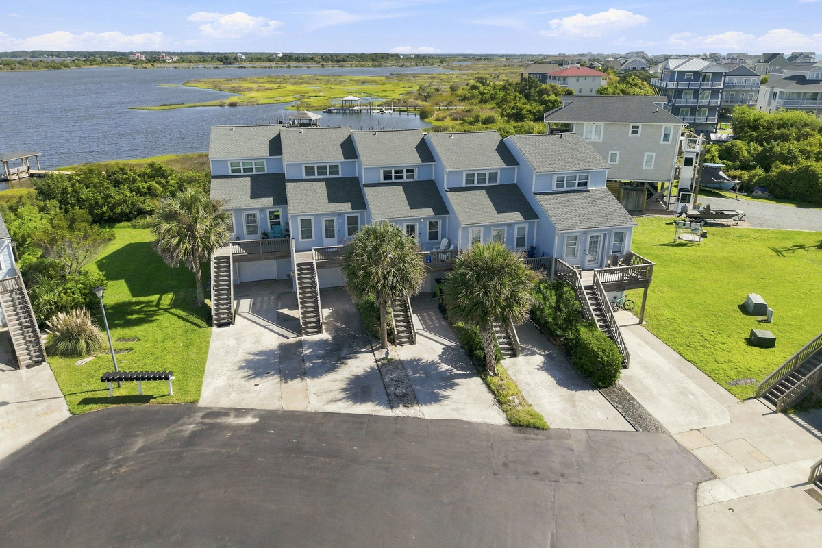Enjoy the best of both worlds with charming blue townhomes situated right between the sound and the sea.