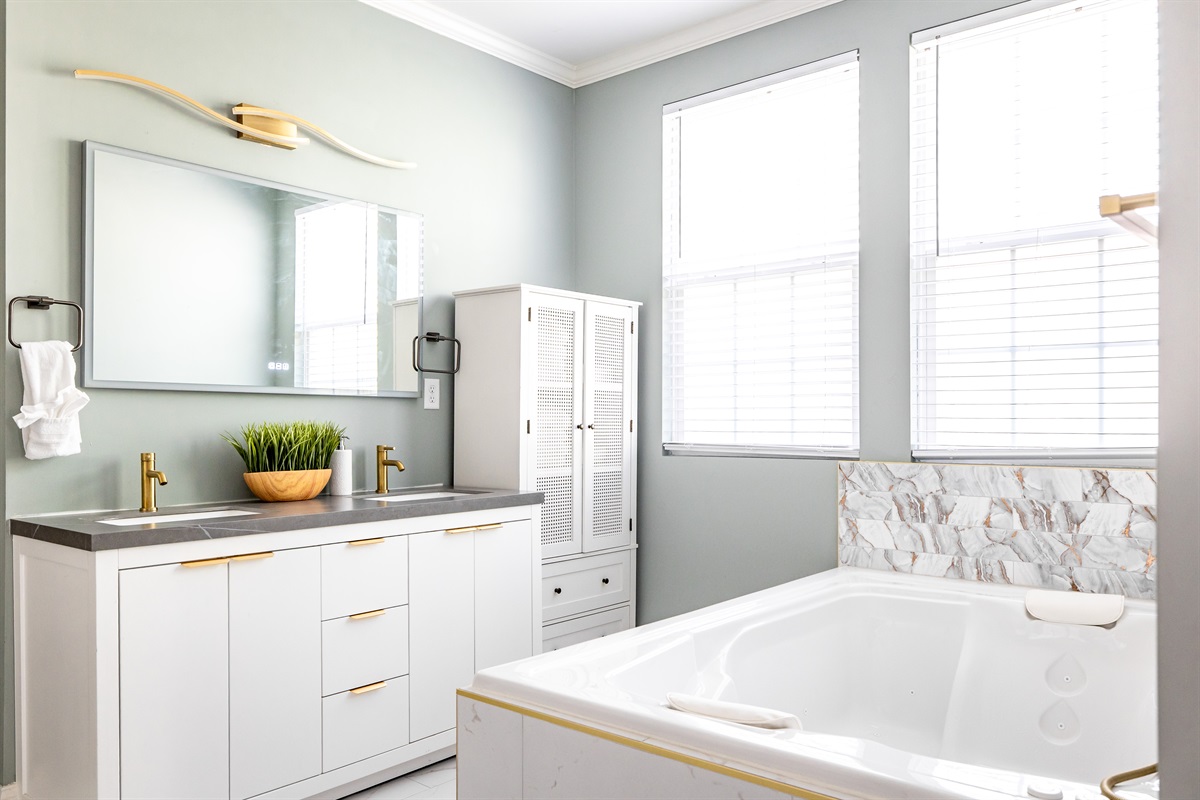 Luxury en-suite bathroom with 2-person air massaging bath, tiled rain shower, and double vanity