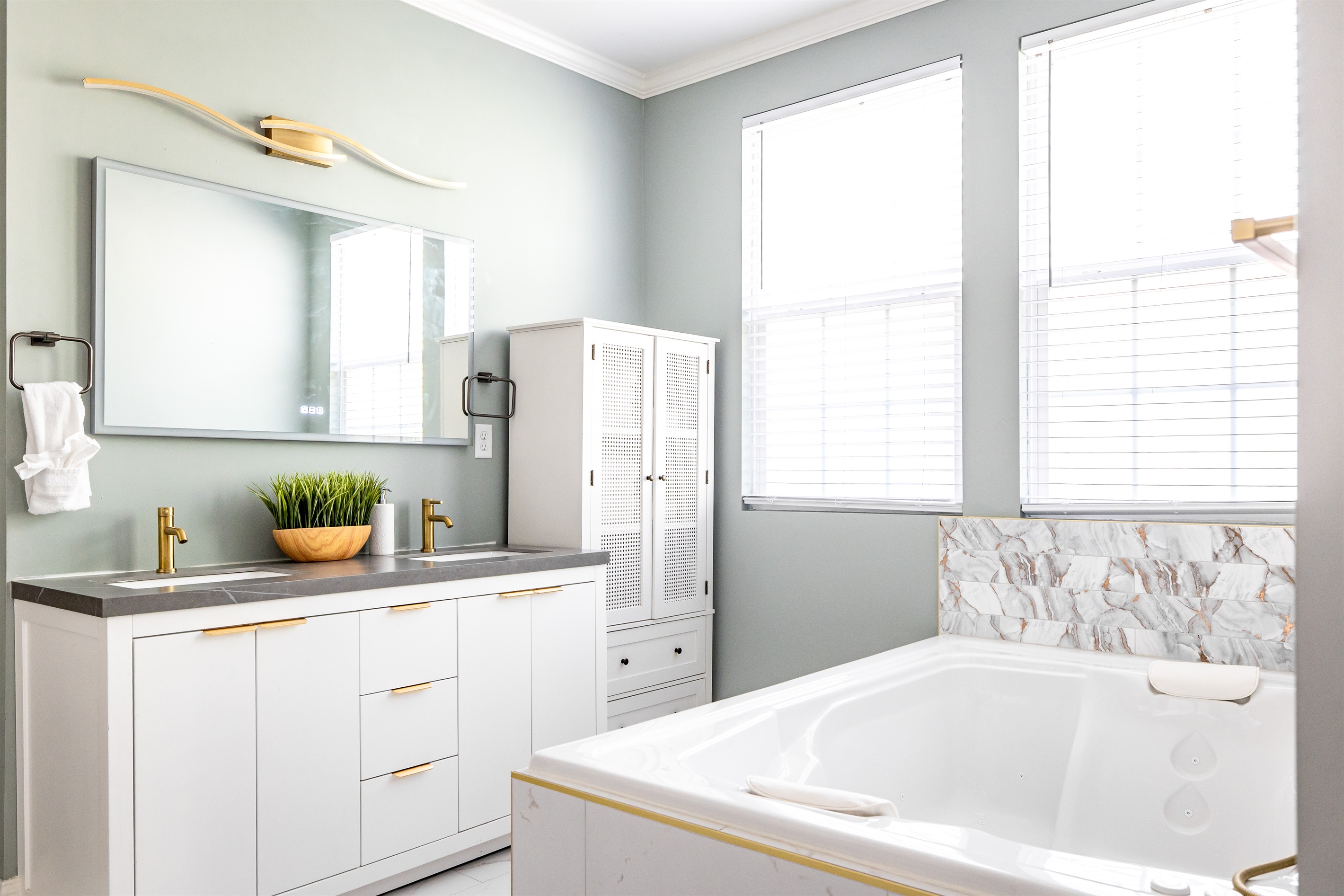 Luxury en-suite bathroom with 2-person air massaging bath, tiled rain shower, and double vanity