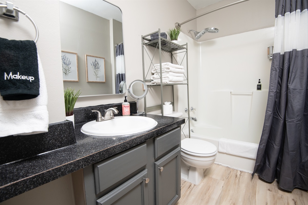 Here is your first full-sized bathroom located in the hallway of E. Bath and shower mix! Bring your favorite bubble bath! Both bathrooms come complete with shampoo, body wash, conditioner, hand soap, and all the linens you need for a comfy stay.