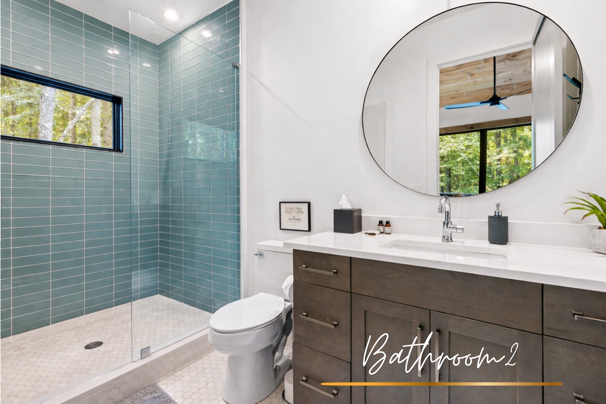 The second bathroom features a walk-in shower, elegant fixtures, and thoughtful modern touches.