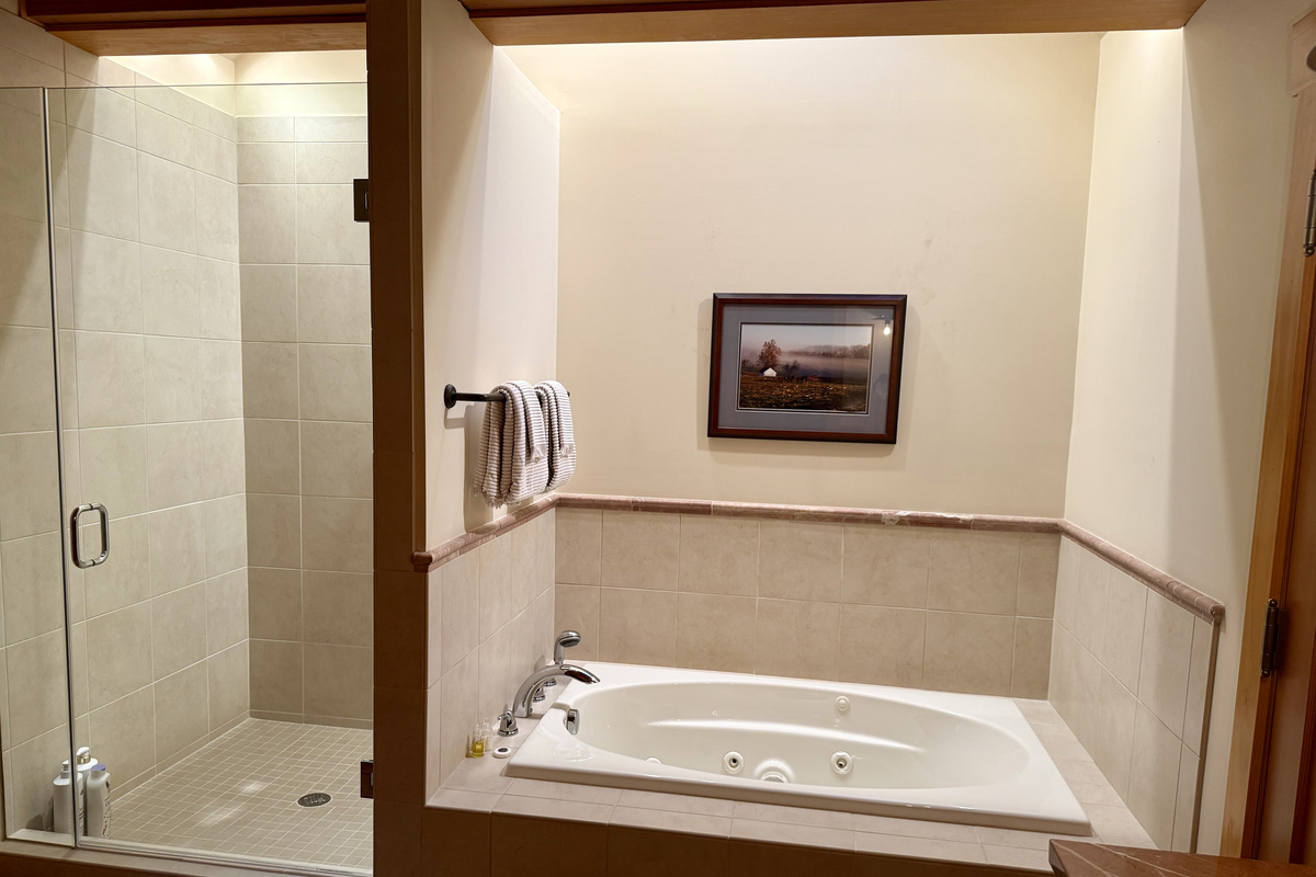 The carriage house includes its own private bathroom, separate from the main house, with a soaking tub and a large walk-in shower for added comfort.