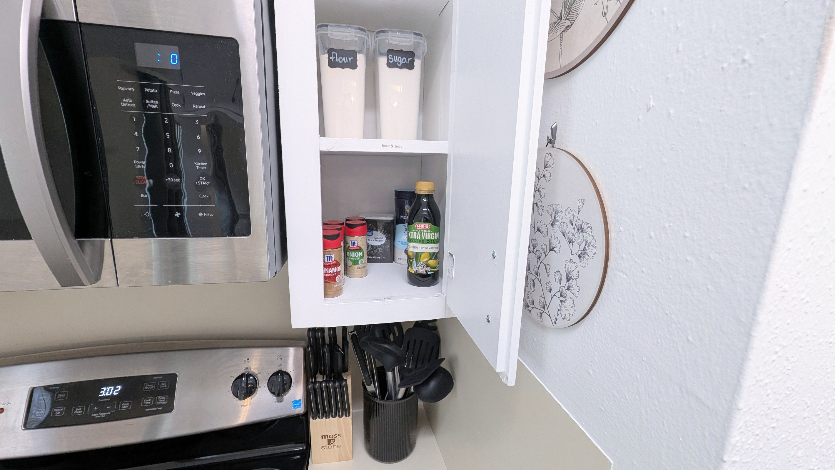 You’ll find essential staples like spices, oil, sugar, and flour stored by the stove, along with knives and cooking utensils for easy access.