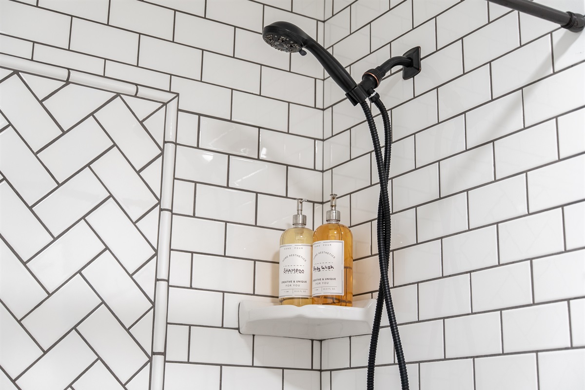 A clean and modern shower space fully stocked with premium essentials.