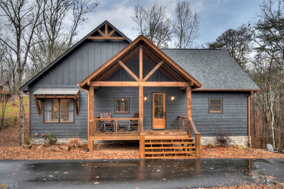 Exterior view of the front of our cabin.  Rocking chairs for hanging out.  Steps are lighted at night for better visibility.