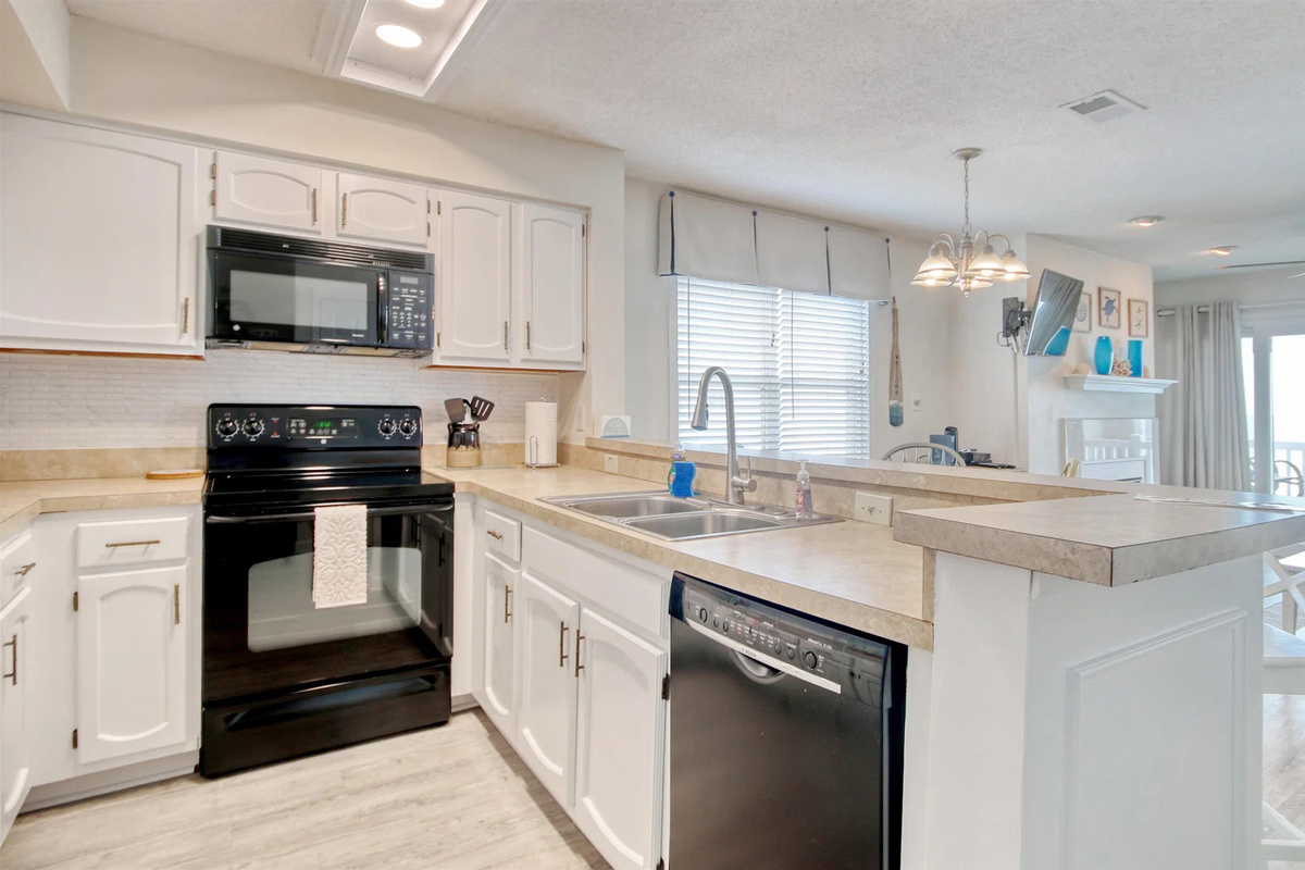 Kitchen with range, microwave and dishwasher