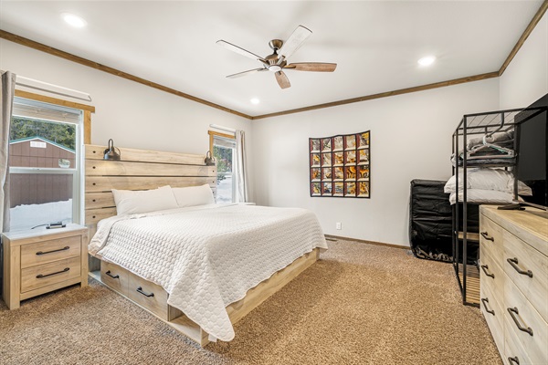 Primary bedroom with king bed and attached private bathroom