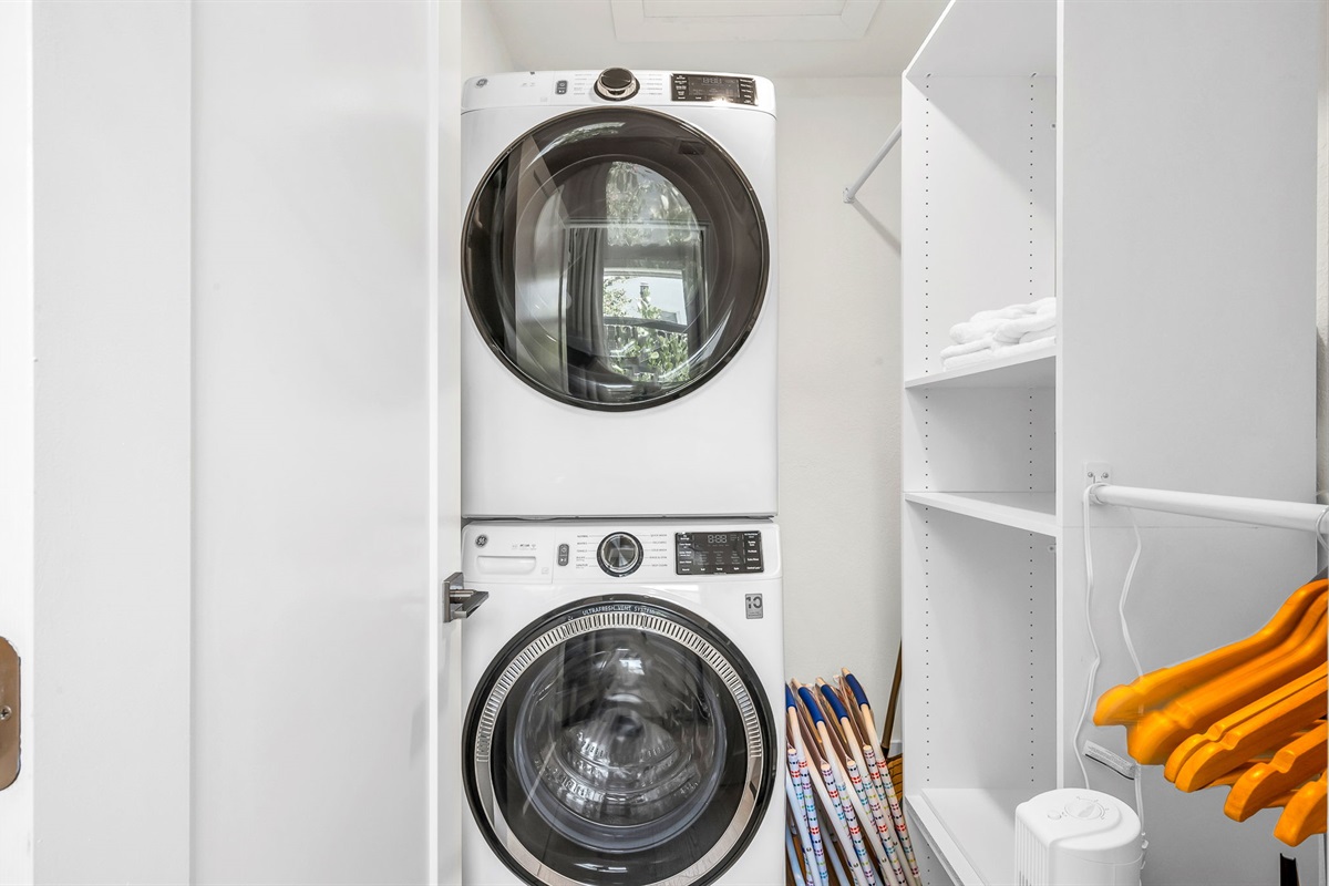 Full-size laundry station with high-capacity washer and dryer, built-in shelving, and beach gear storage—perfect for extended stays and added convenience during your Palm Beach getaway.